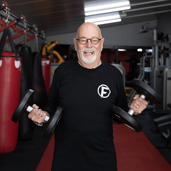 Photo of Aspire4Life client holding dumbbells